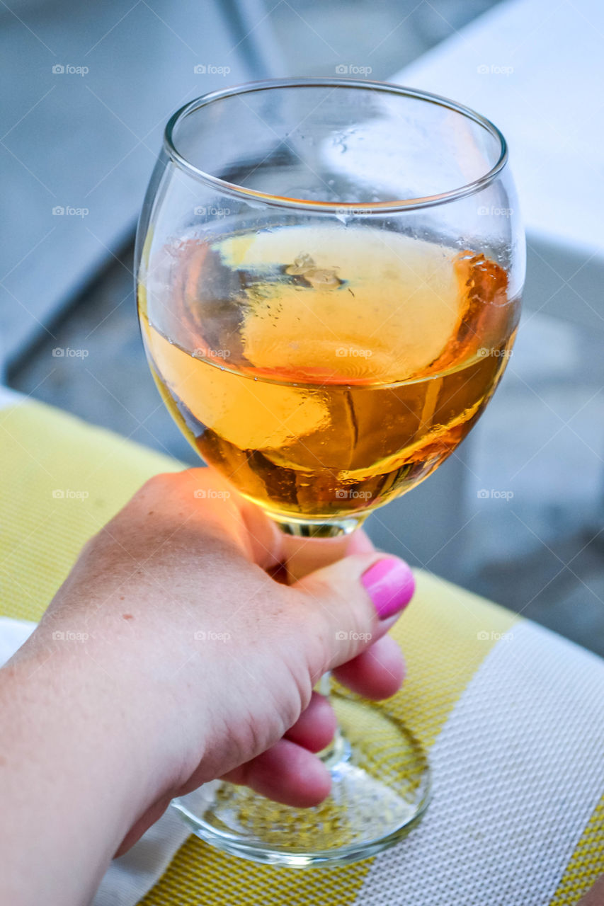 Woman’s hand holding a glass of ciders 