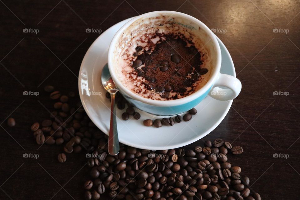 A cup of coffee and coffee beans