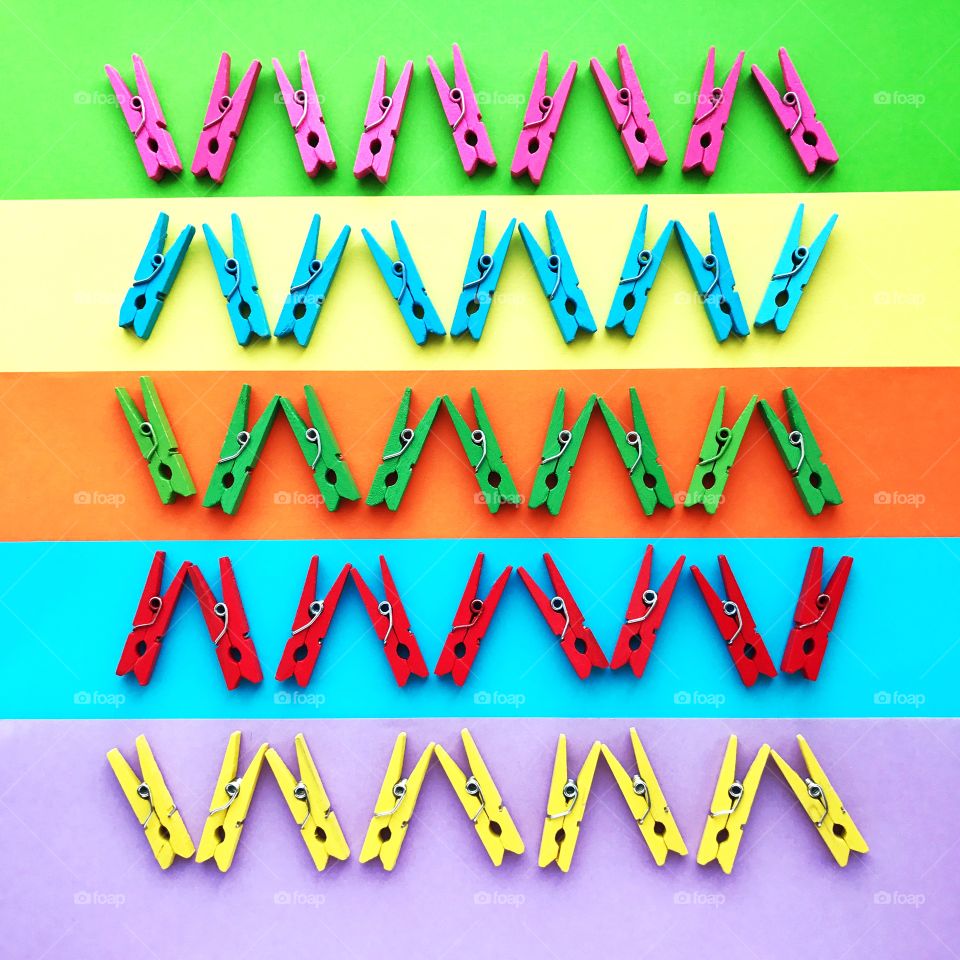 Colorful pins on colored background