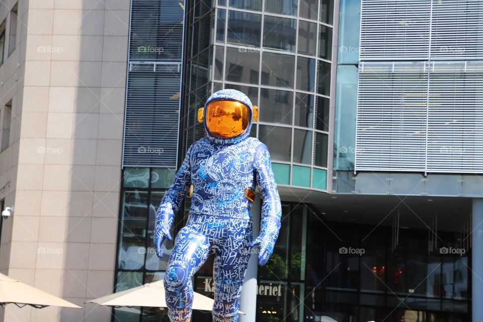 Astronaut walking  in town?