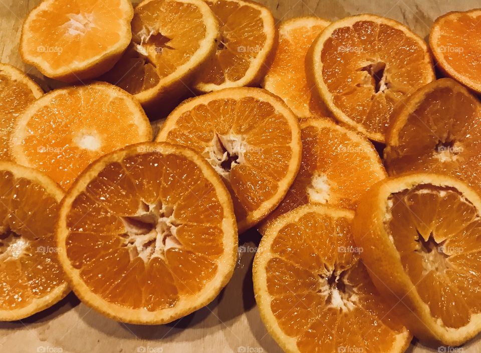 Orange slices on a wooden cutting board - circular shaped fruit slices 