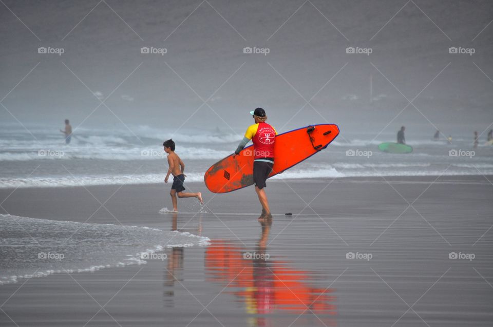 surfing on famara beach on lanzarote canary island in Spain