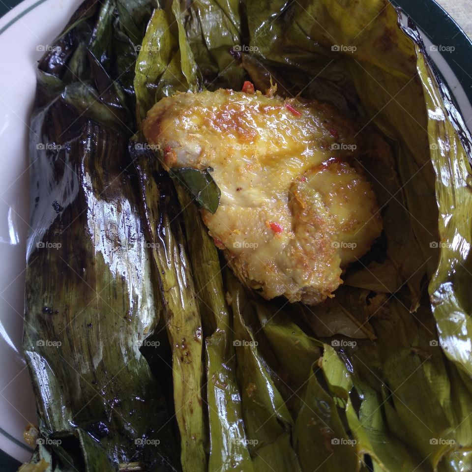 Steamed chicken wrapped in banana leaves