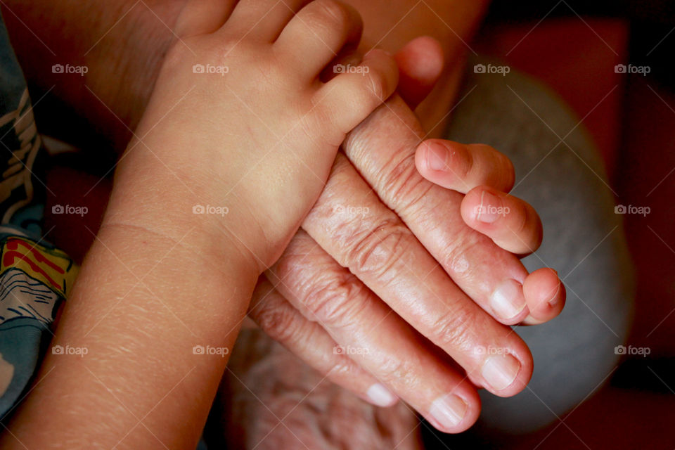 Hands of great-grandson and his great-grandmother