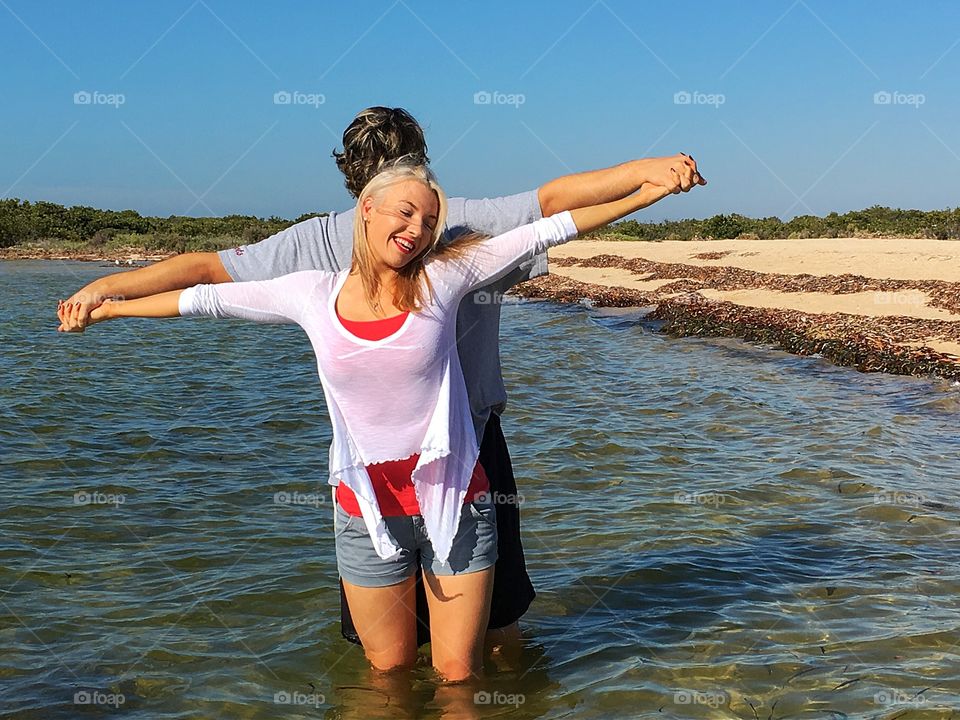 Man and woman posing in sea