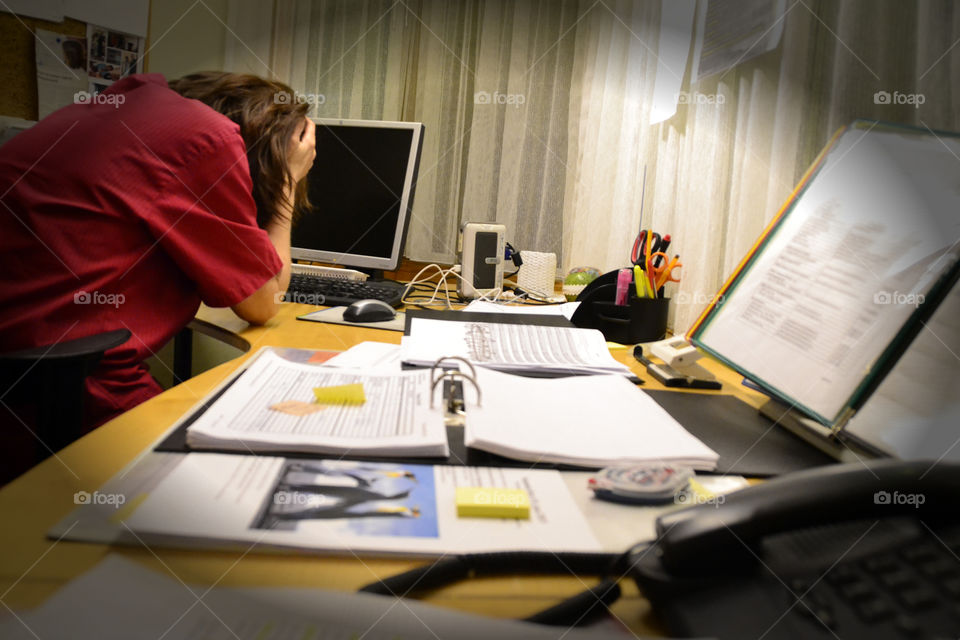 Frustrated Woman at work . Frustrated over endless paperwork 