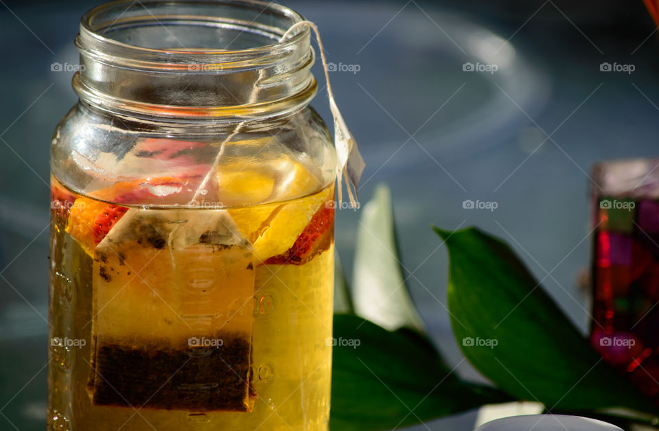 Close-up of green tea in jar on table