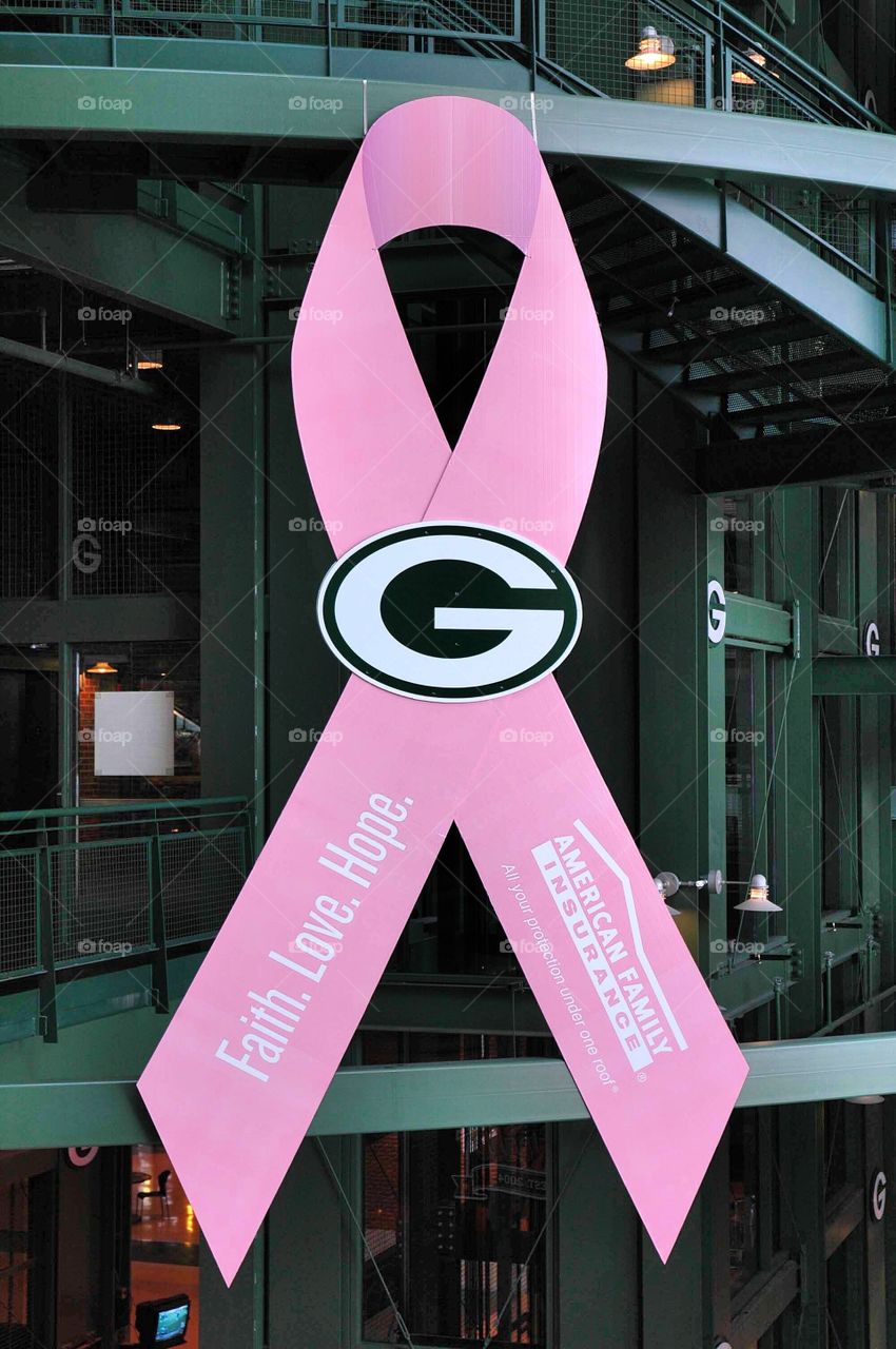 Stadium . A very large breast cancer awareness ribbon hangs in Lambeau Field in Green Bay Wisconsin.