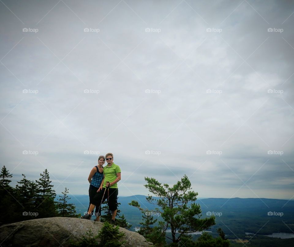 Couple  hiking  in  mountains  on  cloudy  day 
