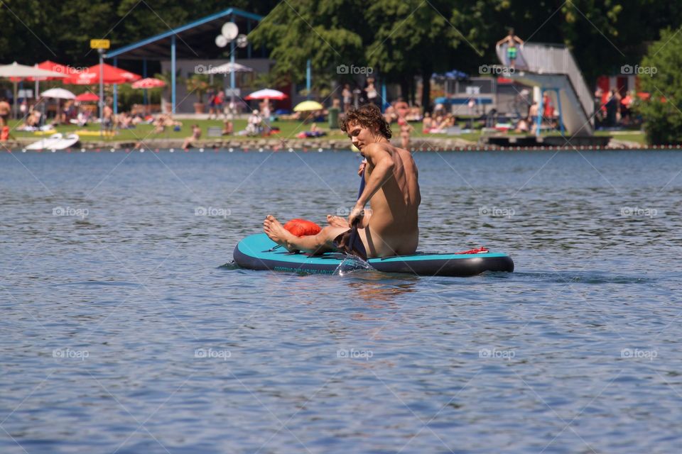 Naked Guy Rowing On Lake