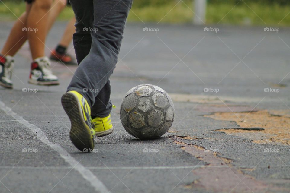 children in the old stadium play football.