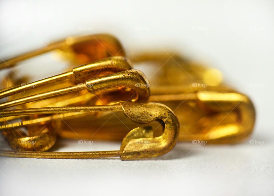 Yellow pins on a white background.