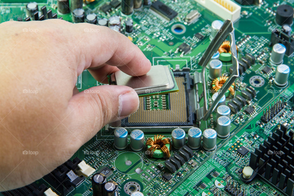 CPU in hand before installation into the motherboard