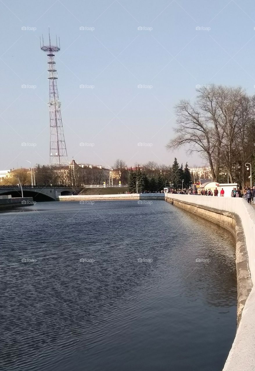 cityscape river shore and people walk