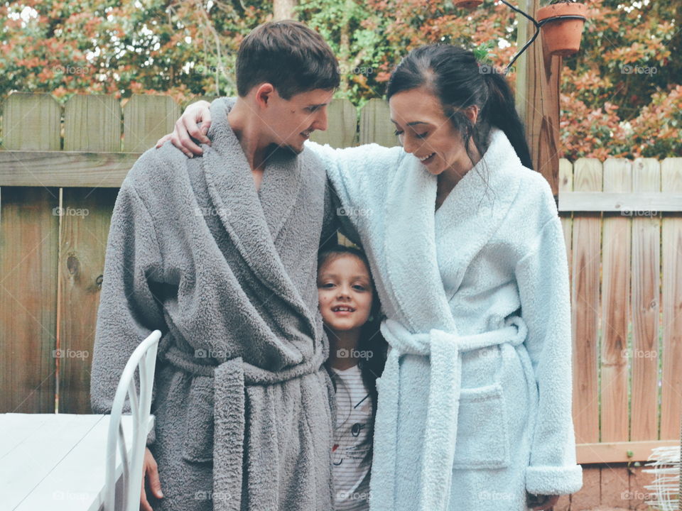 family in robes with child