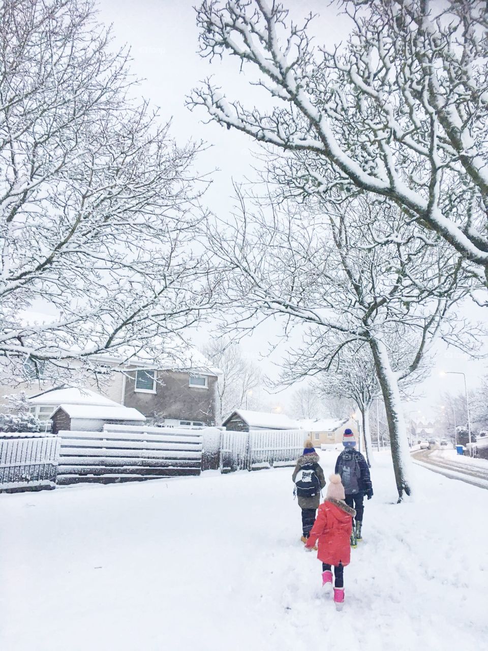 Children walking outdoor on snow day.