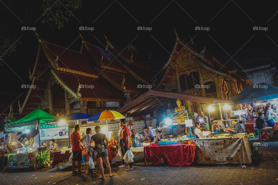 Night market vendors in front of temples in Chiang Mai, Thailand 