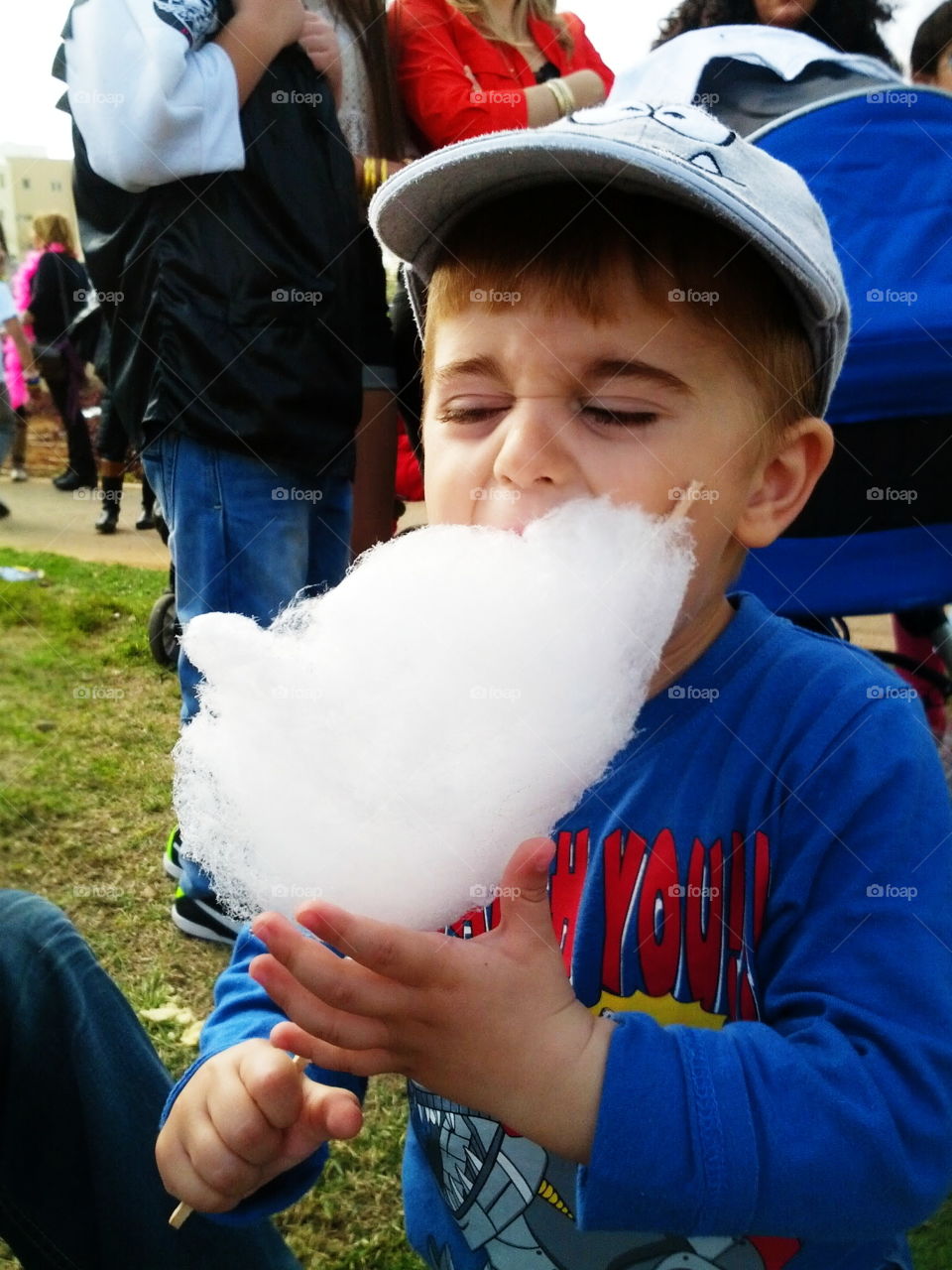 wool sugar. boy enjoys eating sugar wool