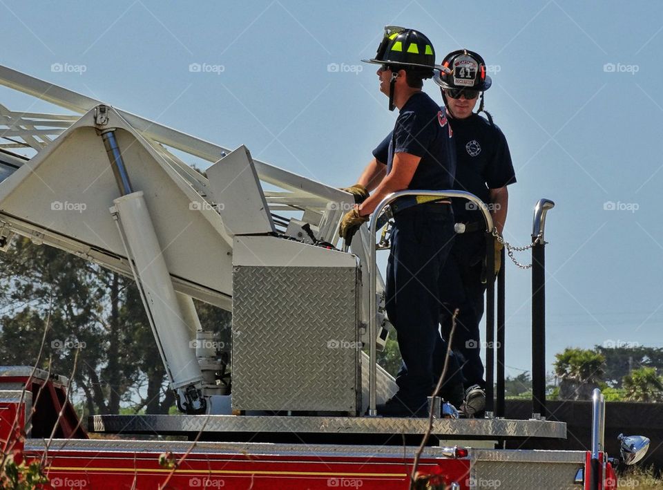 Firemen working on a ladder