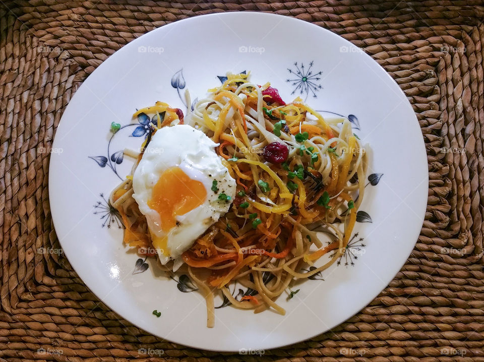 Whole wheat pasta and egg on table
