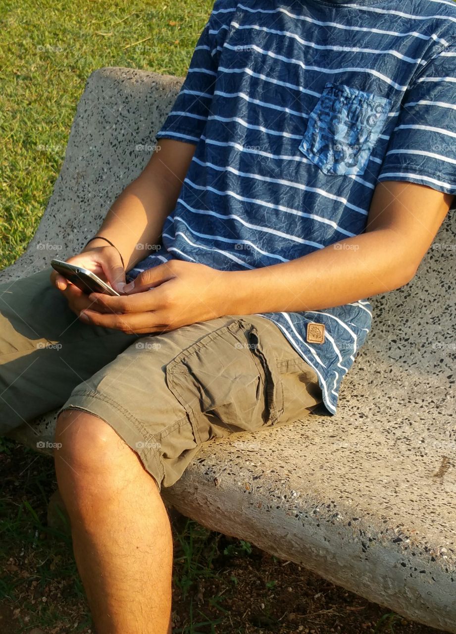 Mobile user. Guy holding smartphone.
cellphone mania