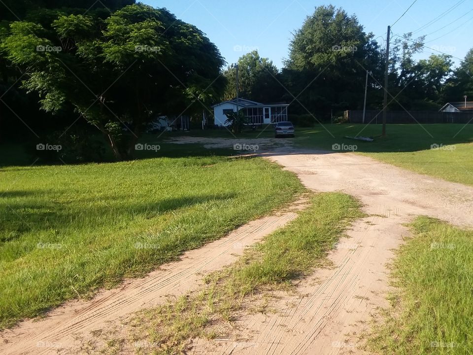 a worn out driveway leading to an old Jim Walters house