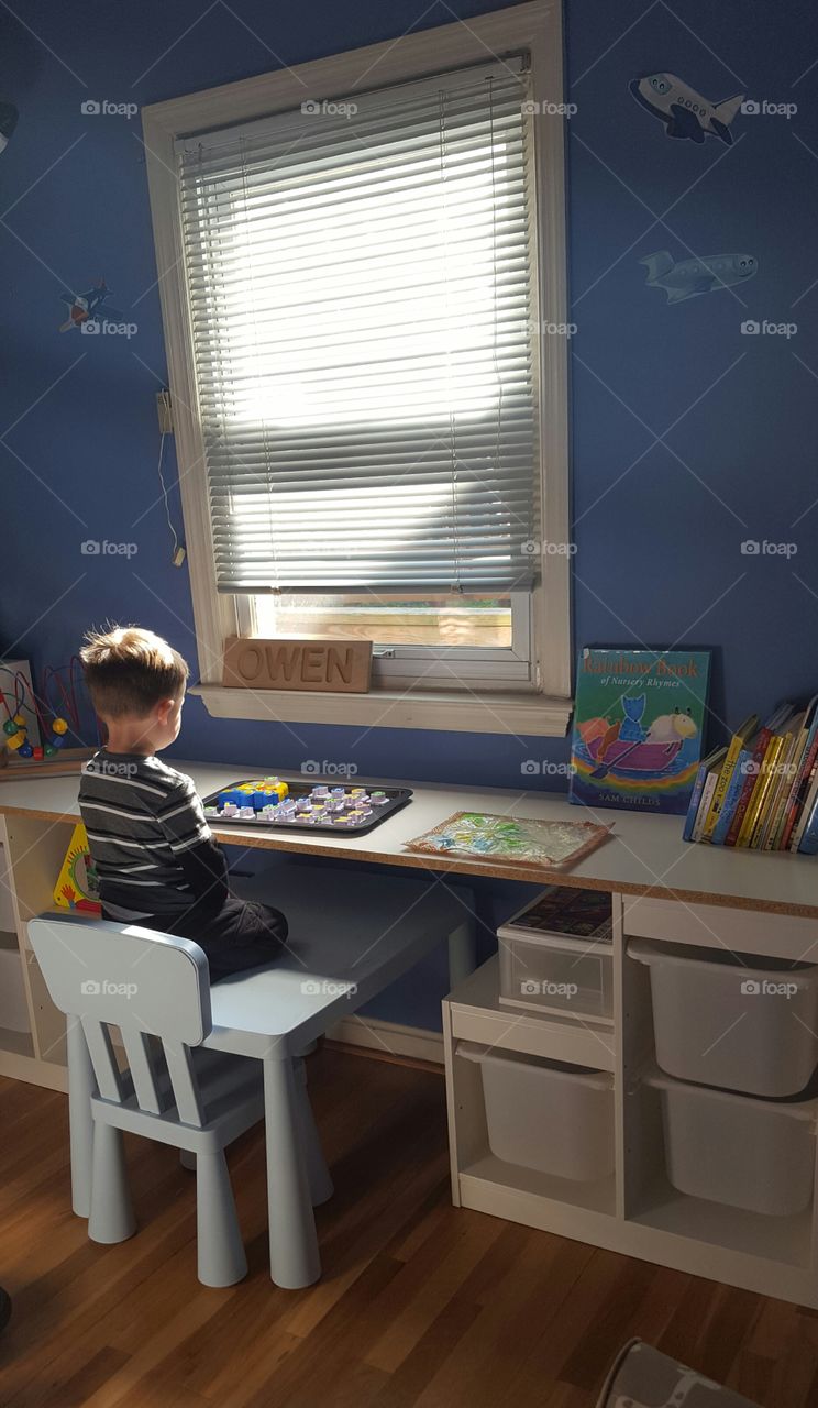 Little man enjoying a quiet morning learning his alphabet.