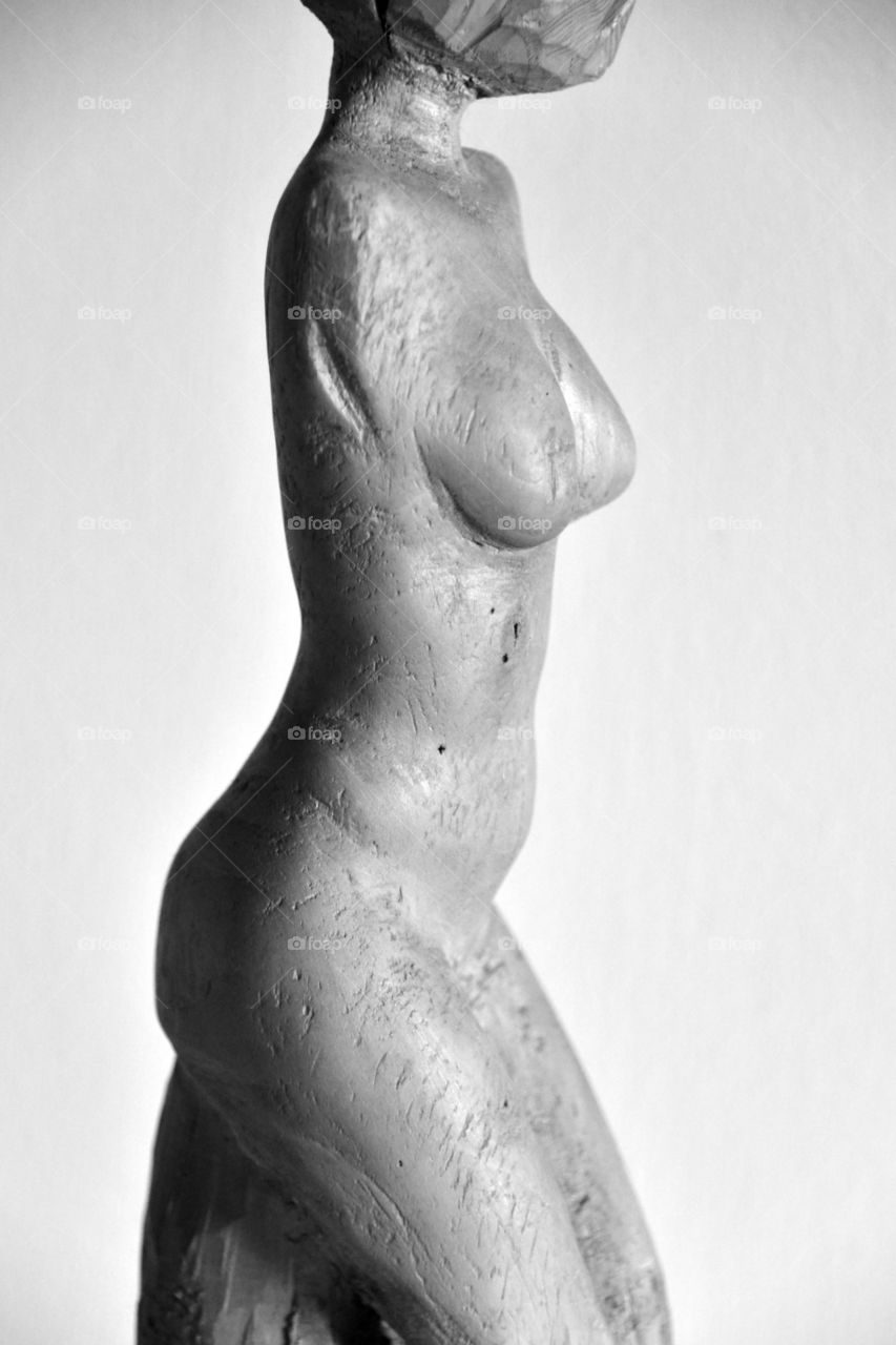 naked body of a woman, wood carving