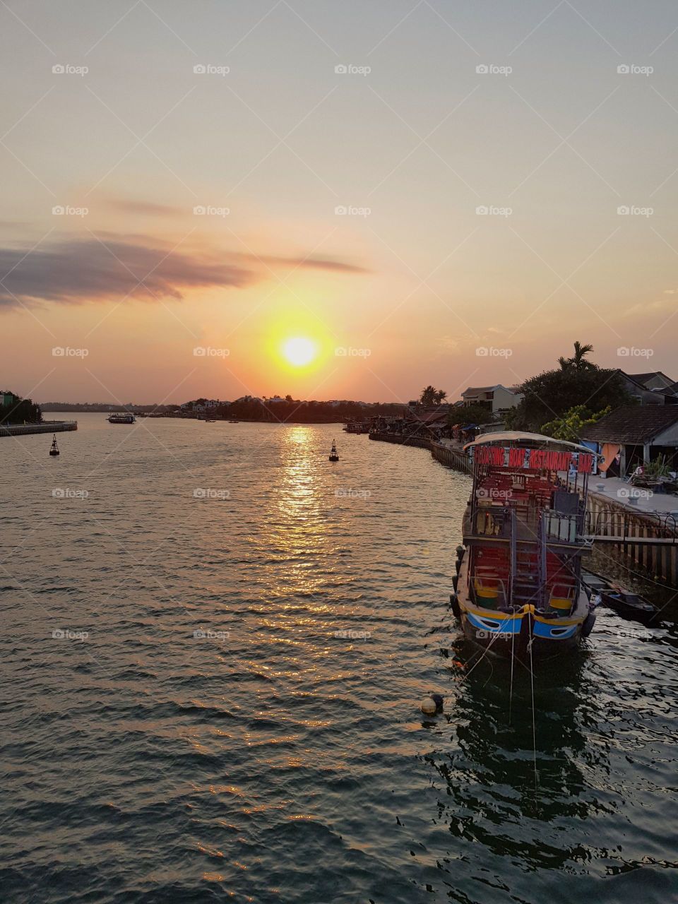 Beautiful sunset in Hoi An, Northen Vietnam. Perfect place to sit down, relax and spend time with a loved one until the sun goes down.