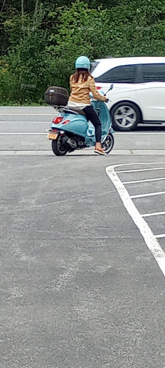 Blue Scooter Rider Entering the Road