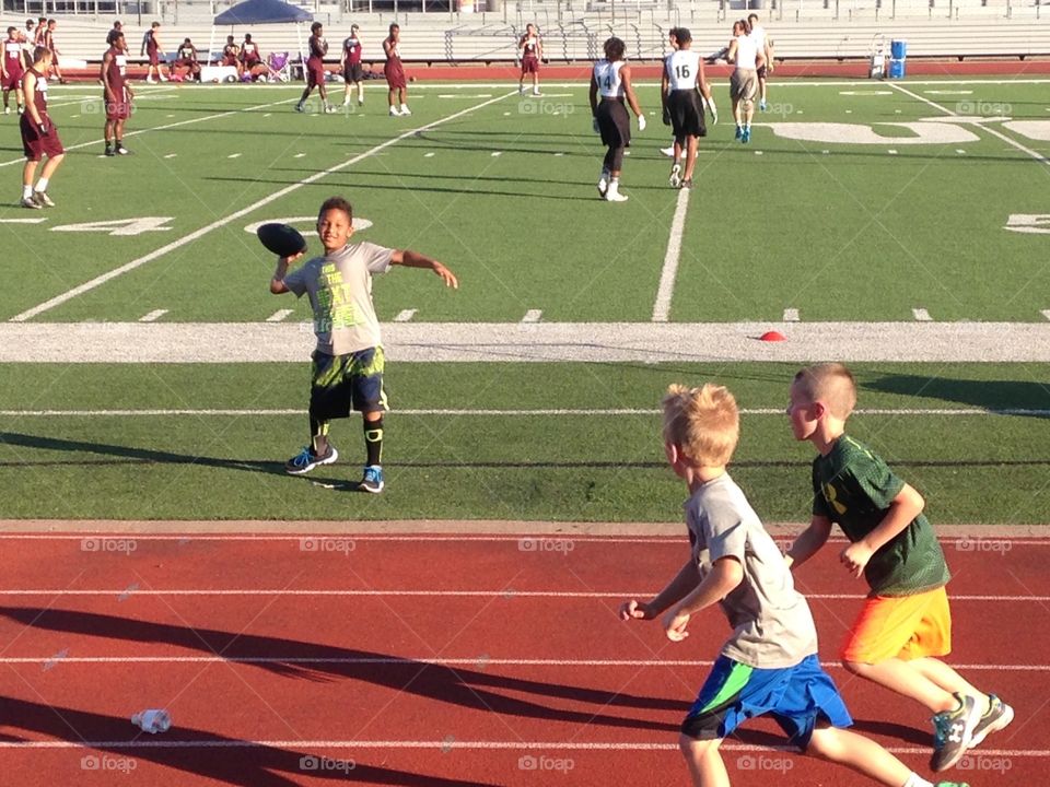 When I grow up. Little boys playing football at aFootball game