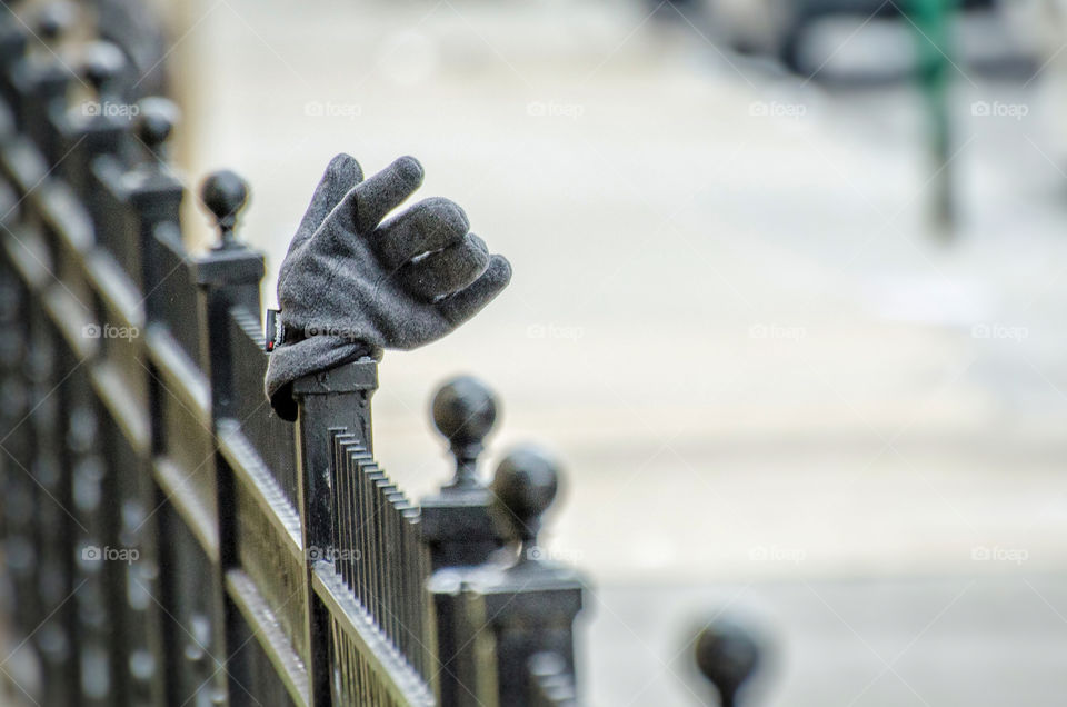 Close-up of glove on metallic fence