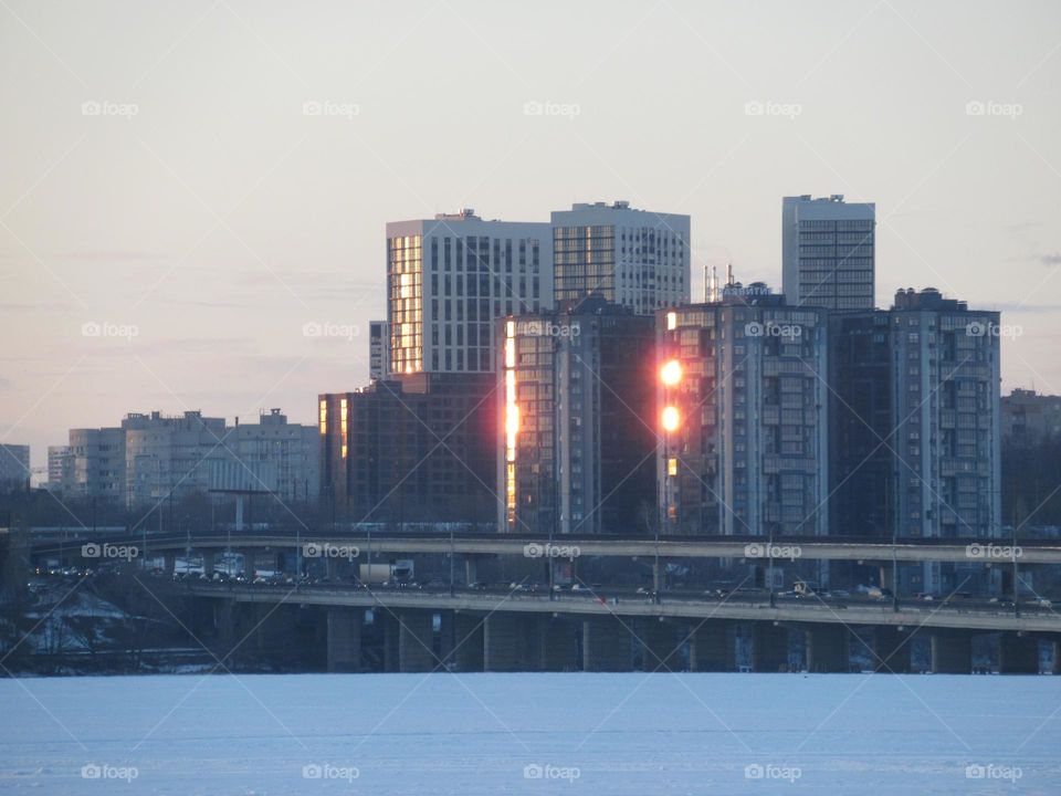 city ​​in the center of Russia Voronezh, winter, residential buildings, a pond under the ice, the first of March, spring has come