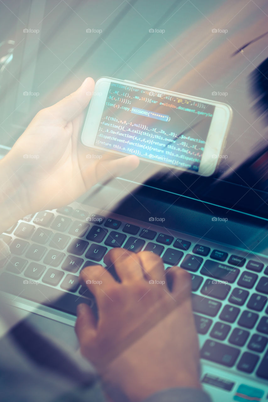 Hacker using computer, smartphone and coding to steal password and private data. Screen displaying program code, website development, application building, password and private data