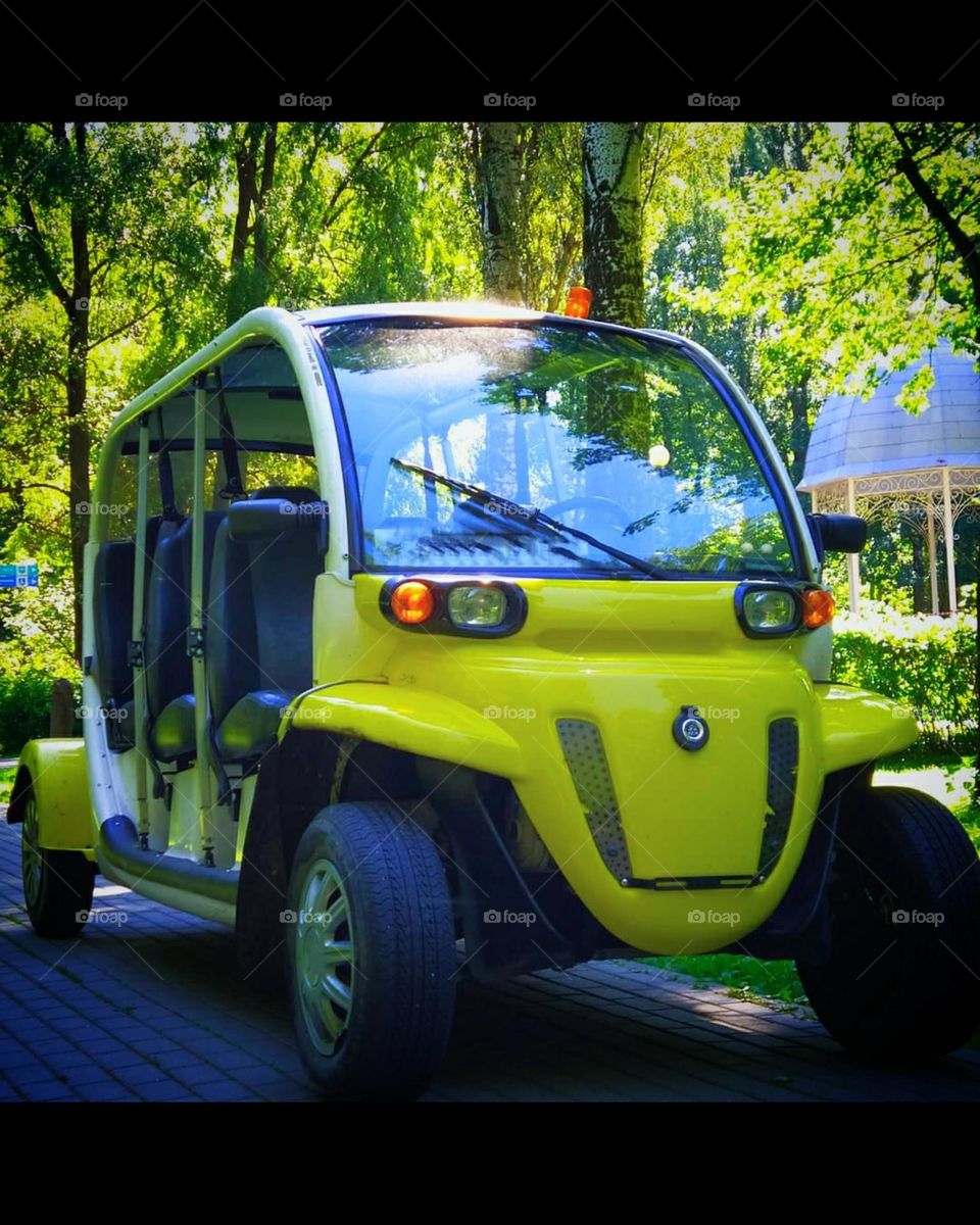 Cars. Yellow car for driving through the park. Smiling car