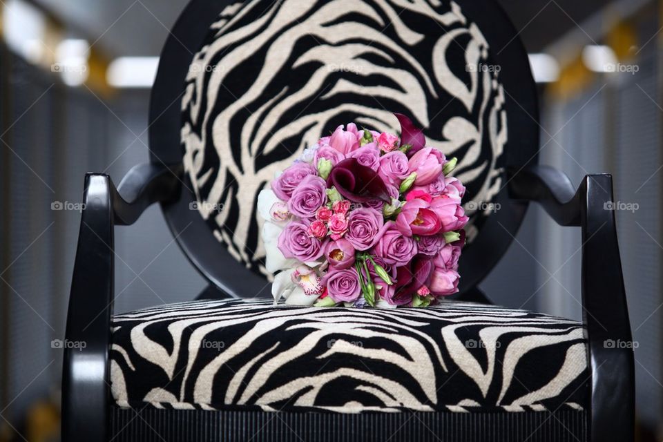 Flower bouquet sitting on a zebra print victorian chair