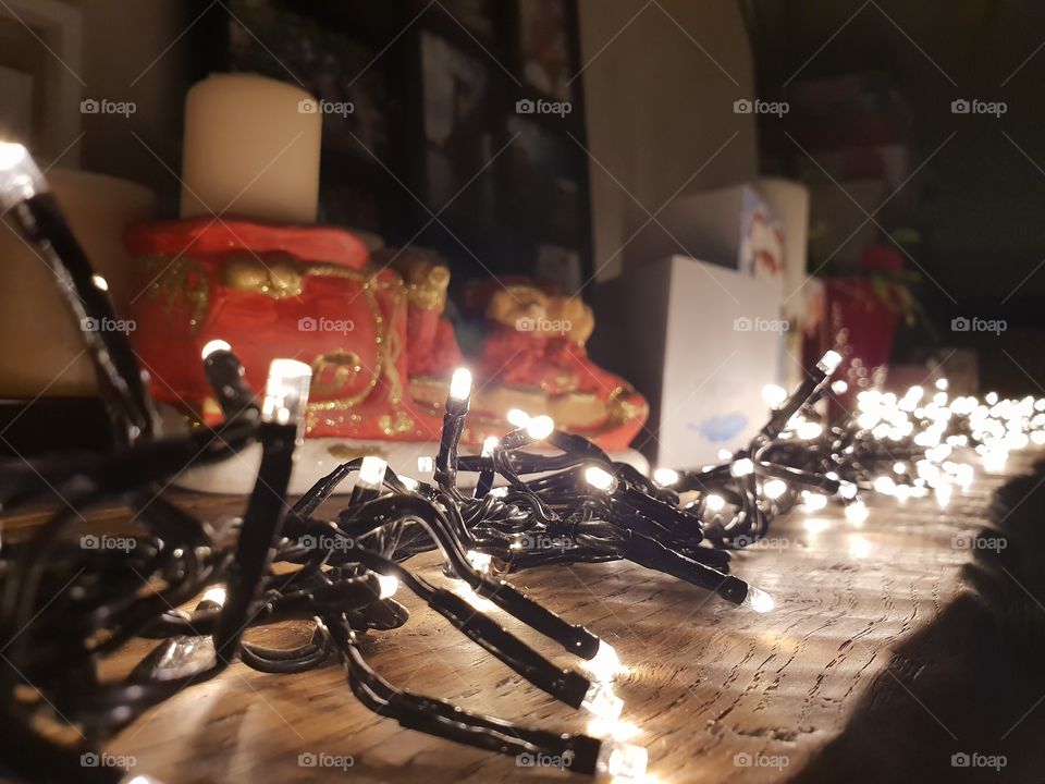 Christmas lights on the wooden beam of the fireplace