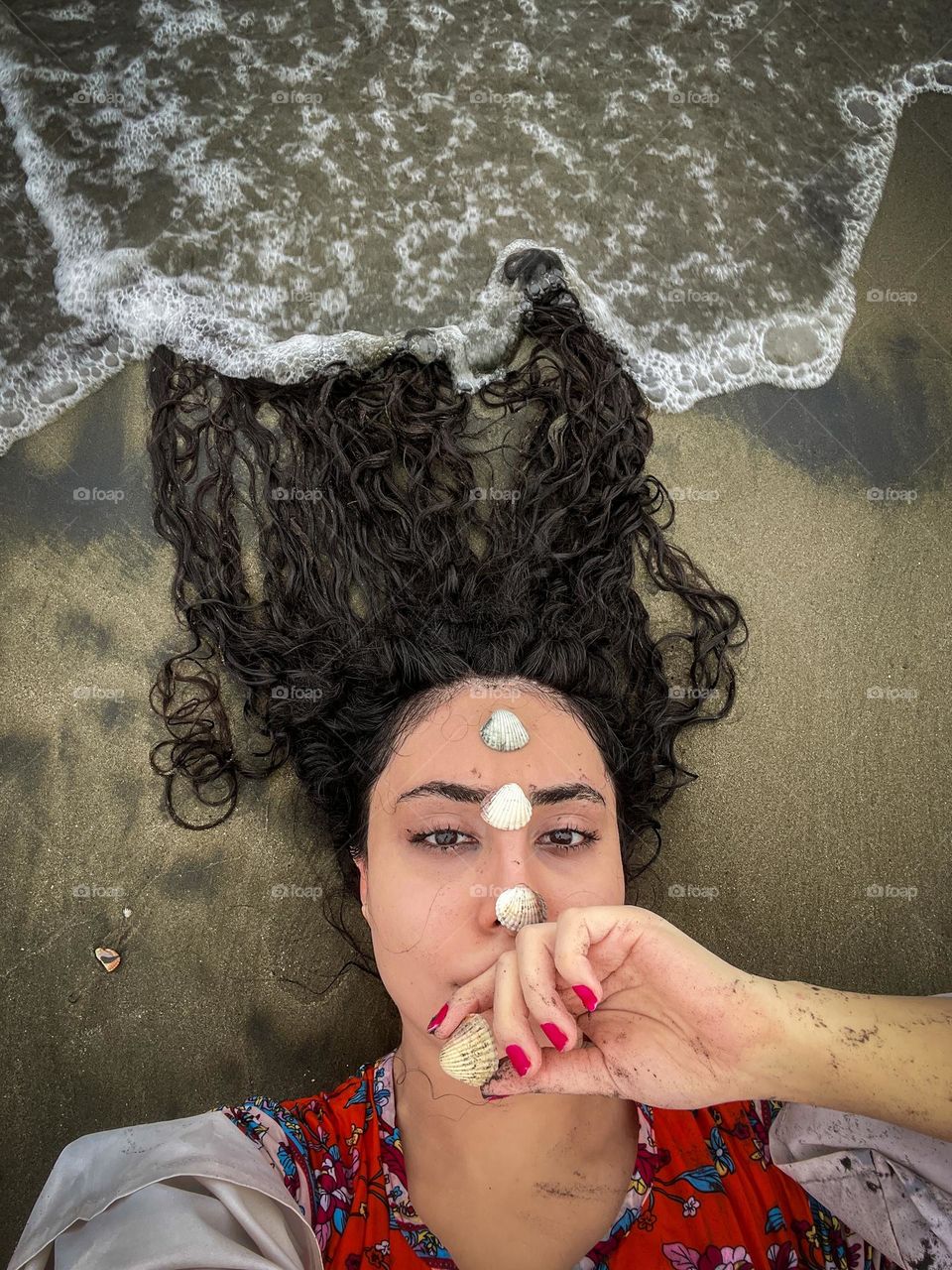 Peaceful connection with the sea, shells and waves blending into calmness.