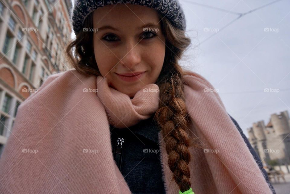 Girl in winter fashion looking in the camera: scarf, hat 