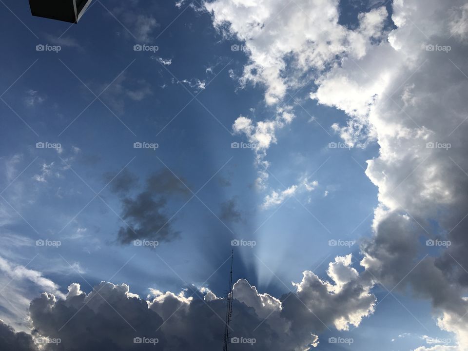 God sure makes pretty pictures! Some clouds blue sky and sun peeking through Awesome!