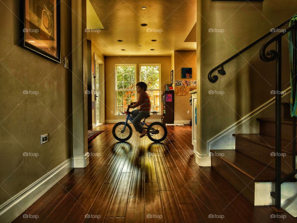 Golden Hour Home Scene. Riding A Bike Inside With Warm Ambient Light
