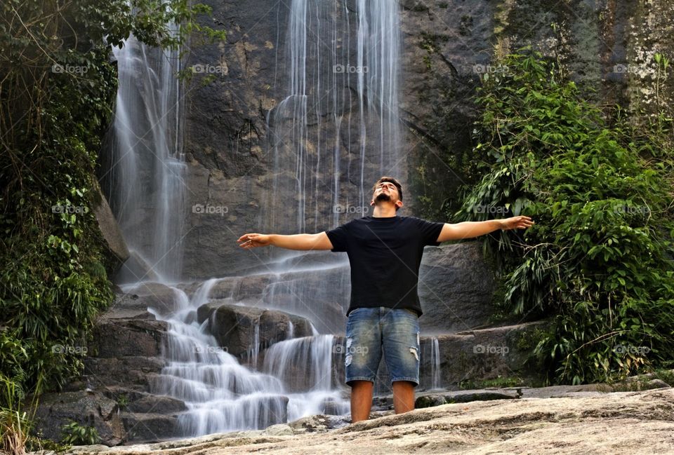 Boy at waterfall