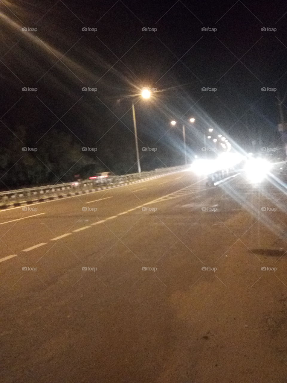 a beautiful road seen at night