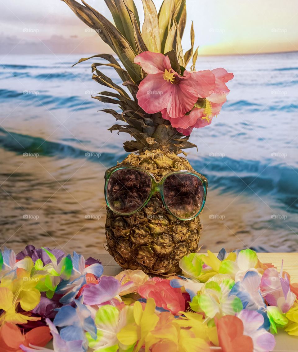 Here my 100% natural model, shows off the latest authentic beachwear in front of an ocean sunset - yes it’s a pineapple in sunglasses!