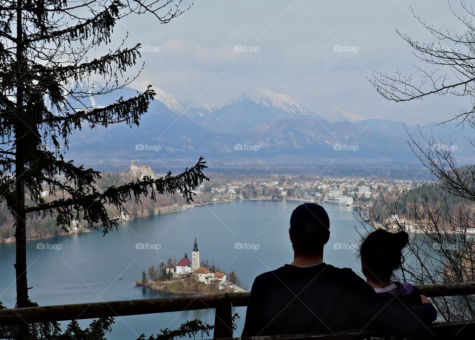 Couple admiring view of lake and mountains.