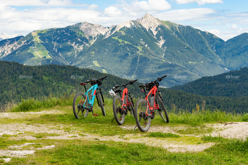 three mountain bikes and a beautiful view  in the Alps