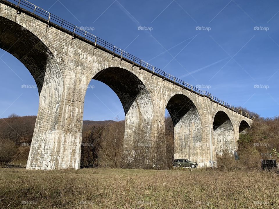 Panorama of a medieval viaduct bride construction for train rail made from stone 