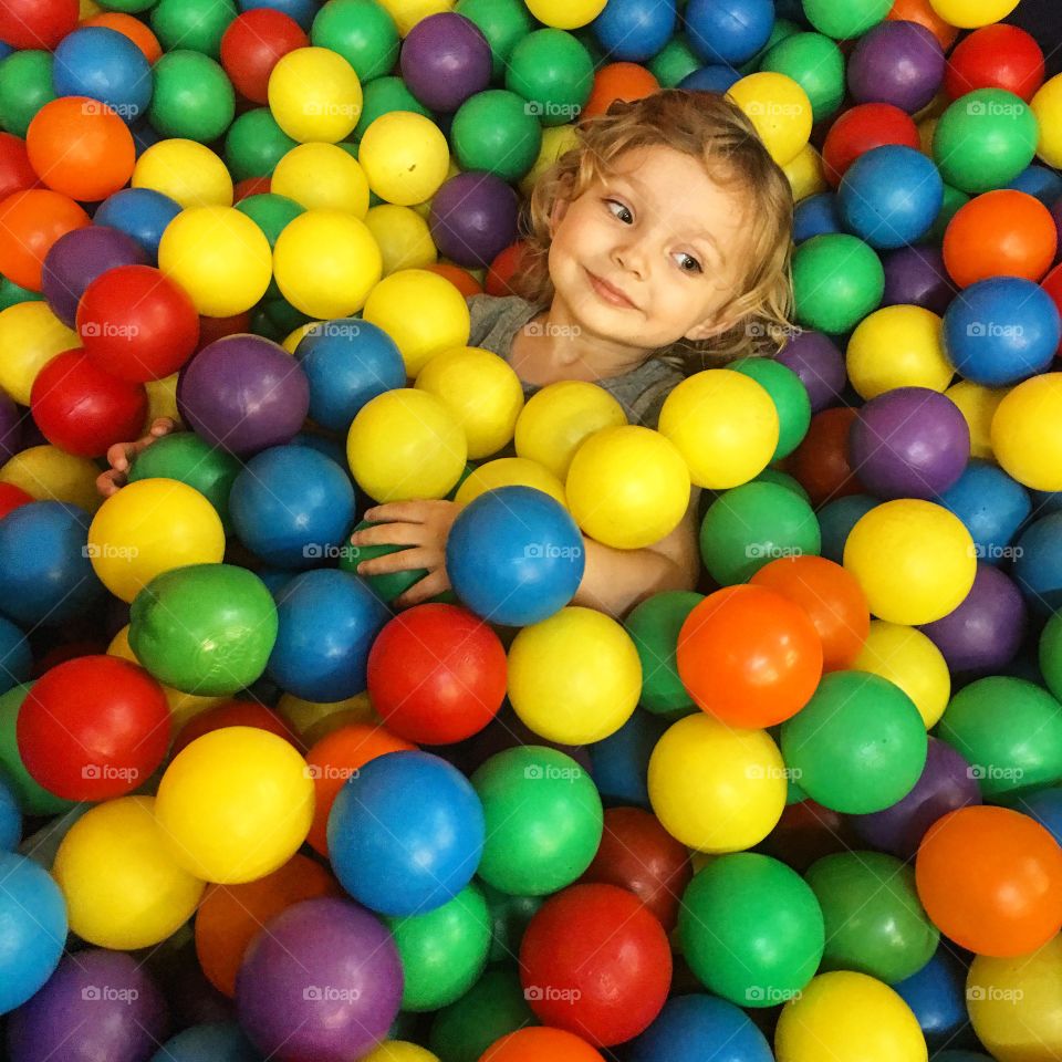Toddler girl fun in a ball pit!