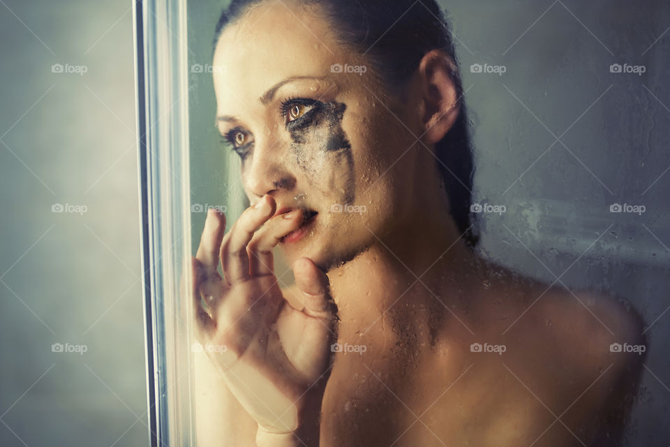 Bad day. Young girl crying in the shower