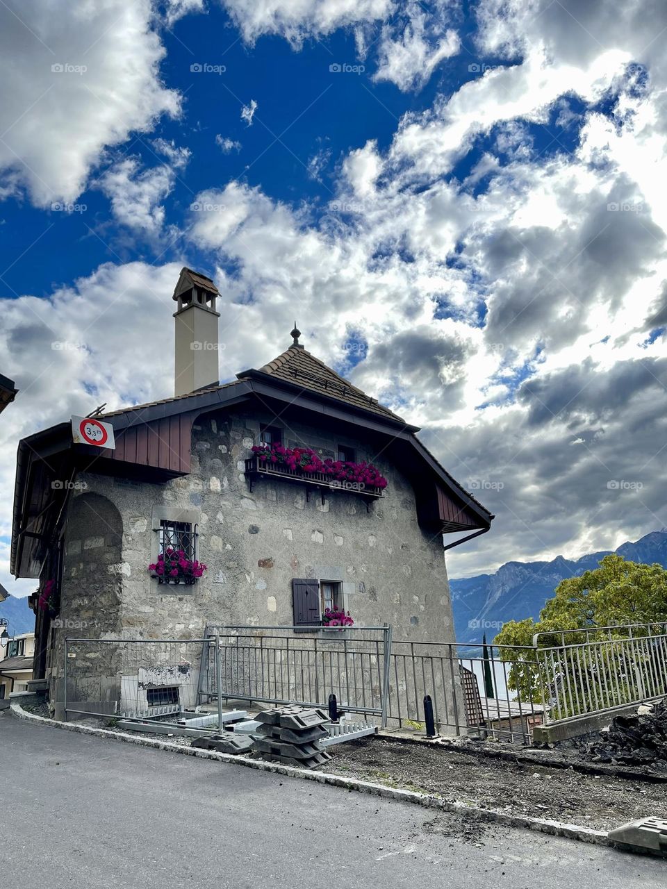 Cloudy blue sky above a typical suisse mountain house in Montreux, Vaud, Switzerland 